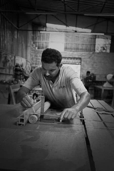 Master carpenter working on wood joint